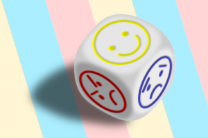 Dice with faces on it. One is smiling, one is sad, one is angry