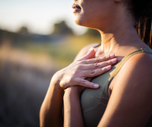 Women outside with hands on upper ribcage