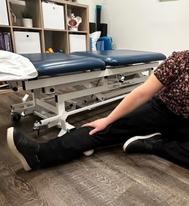 Christine Campbell, Physiotherapist, roller her calf with a tennis ball