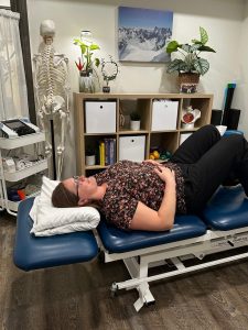 Christine Campbell, Physiotherapist laying on back practicing breathing