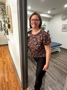 Christine Campbell, Physiotherapist, demonstrating pec release in door frame