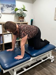 Christine Campbell, Physiotherapist. In 4-point position, demonstrating exercise.