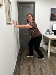 Christine Campbell, Physiotherapist, performing calf stretch by the wall