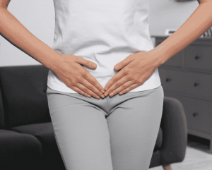 Women with hands on lower stomach
