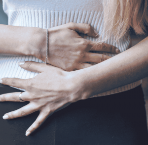 Women holding their stomach with both hands 