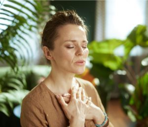 Women with hands on chest practicing breathing