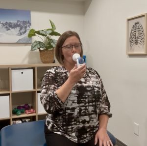 Christine Campbell, Physiotherapist demonstrating how to use Maximal Inspiratory Pressure Device
