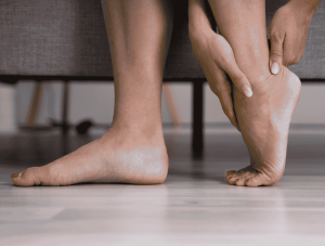 Women touching her Achilles tendon