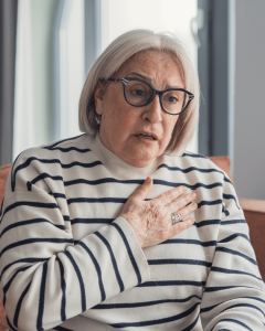 A women clenching her chest.
